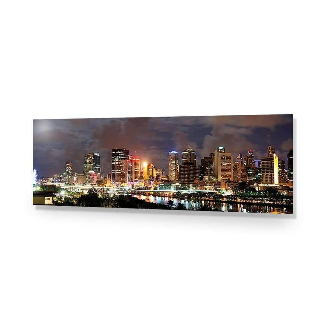 Stretched canvas wall art of Brisbane's skyline at night with cloudy skies and city lights reflecting on the water.