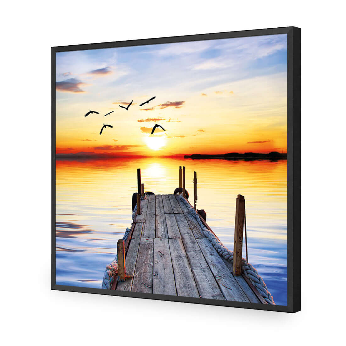 Stretched canvas wall art featuring an abandoned jetty at sunset with birds soaring above the calm water surface.