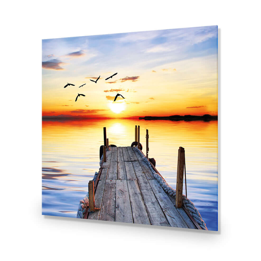 Stretched canvas art of an abandoned jetty at sunset with birds flying over calm water.