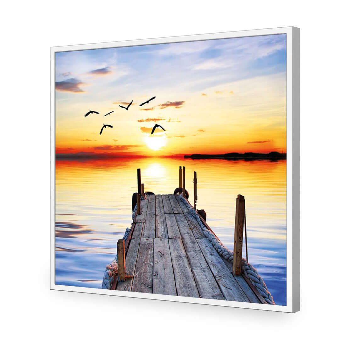 Stretched canvas print of an abandoned jetty at sunset with birds flying over tranquil waters.