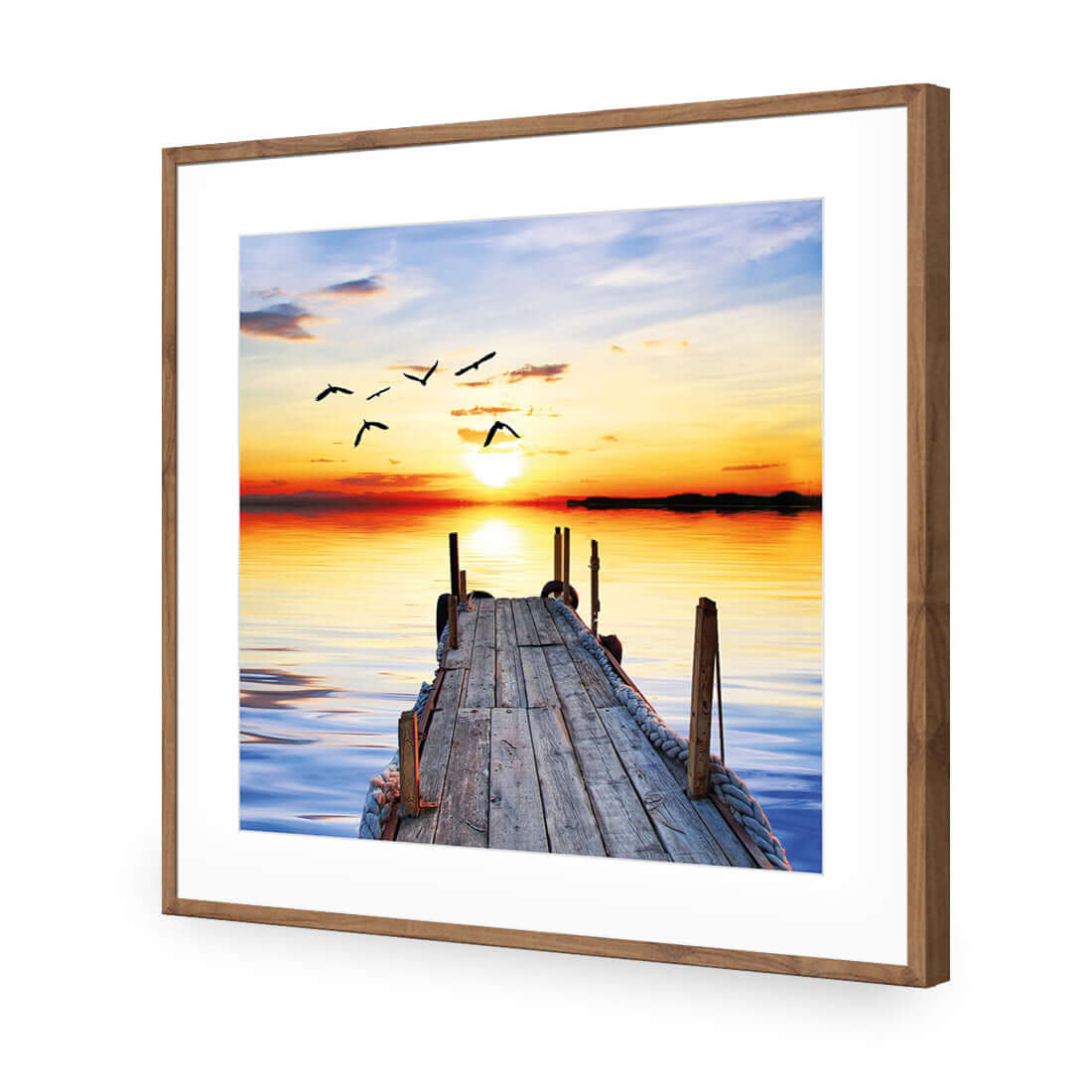 Stretched canvas wall art featuring an abandoned jetty at sunset with birds soaring in the sky.