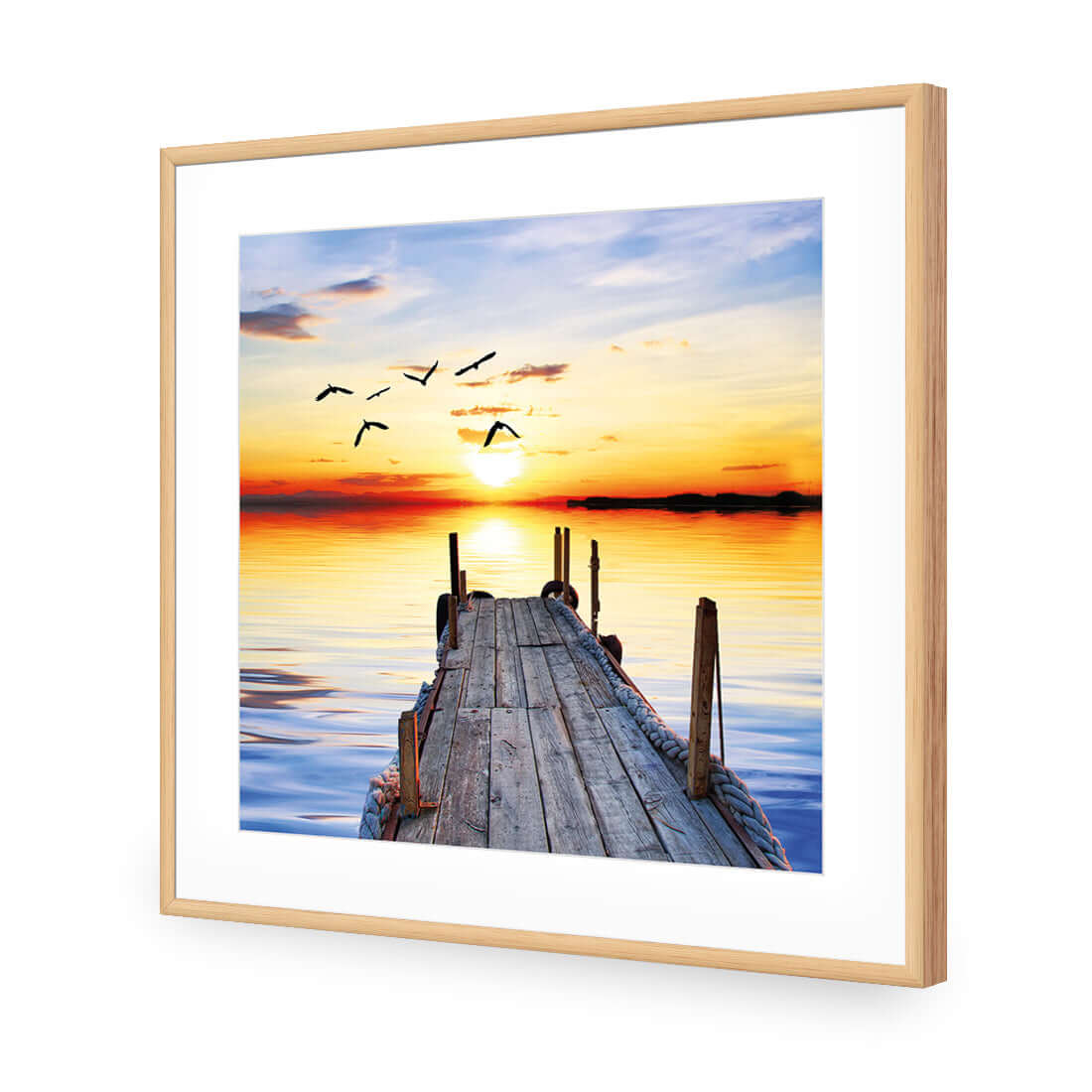 Stretched canvas wall art of an abandoned jetty at sunset with flying birds, enhancing any space with serene beauty.