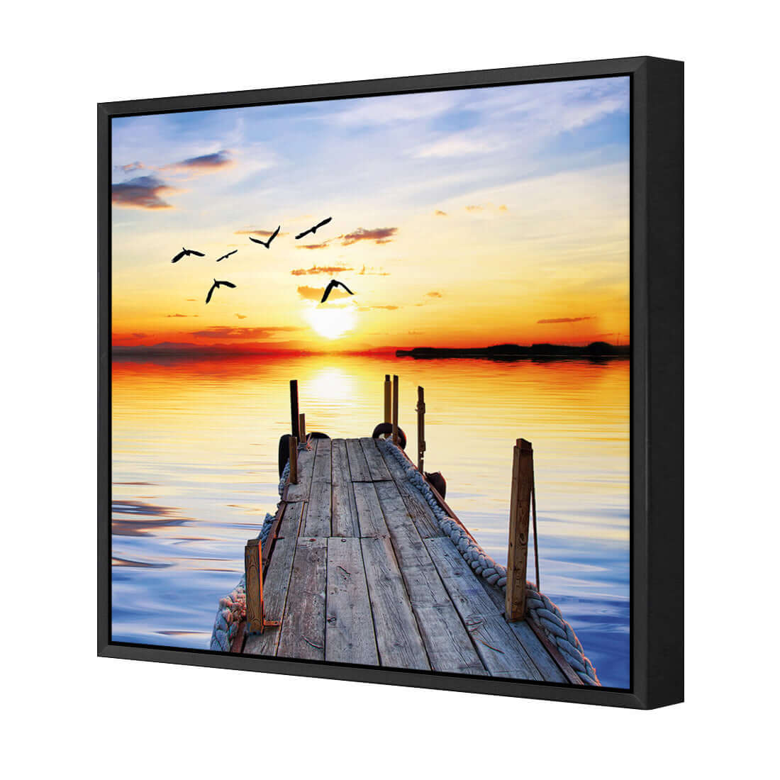 Stretched canvas wall art featuring an abandoned jetty at sunset with birds soaring above the calm waters.