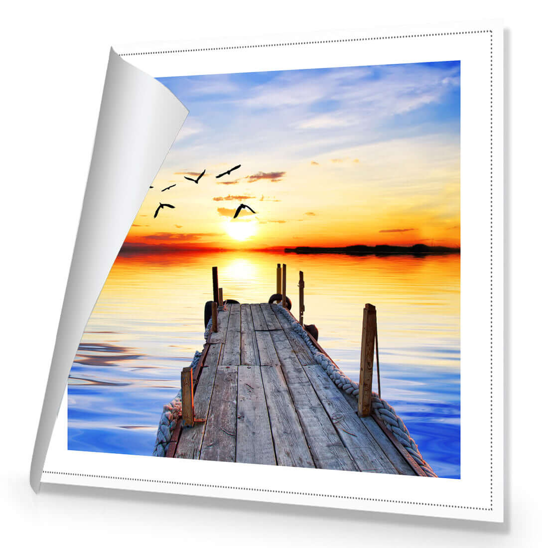 Stretched canvas wall art of an abandoned jetty at sunset with birds flying over calm waters.